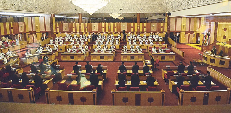 The BN representatives (in ceremonial uniform) face the opposition members, who are dressed in black, in the state assembly. u00e2u20acu201d Picture by Marcus Pheong