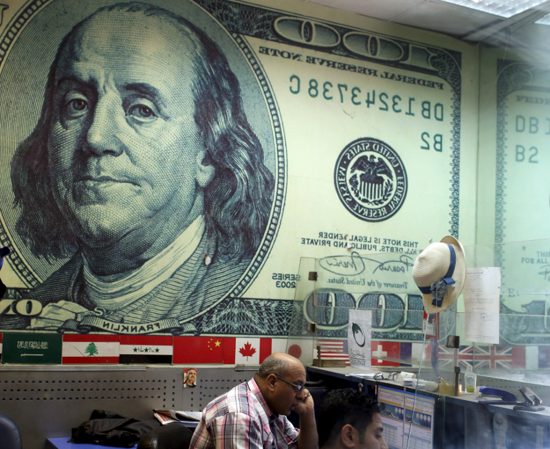 An employee works in a foreign exchange office in central Cairo, April 16, 2015. u00e2u20acu201d Reuters pic