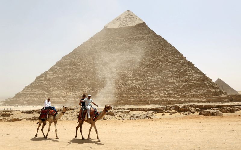 Tourists ride on camels next to the Pyramid of Khufu on the Great Pyramids of Giza, on the outskirts of Cairo, April 30, 2015. u00e2u20acu2022 Reuters pic