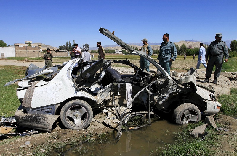 Afghan policemen inspect the wreckage of a vehicle at the site of a roadside bomb at Bihsud district in Jalalabad province, April 22, 2015. u00e2u20acu201d Reuters pic