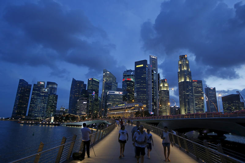 People walk past the skyline of the central business district in Singapore April 13, 2015. u00e2u20acu201d Reuters pic 