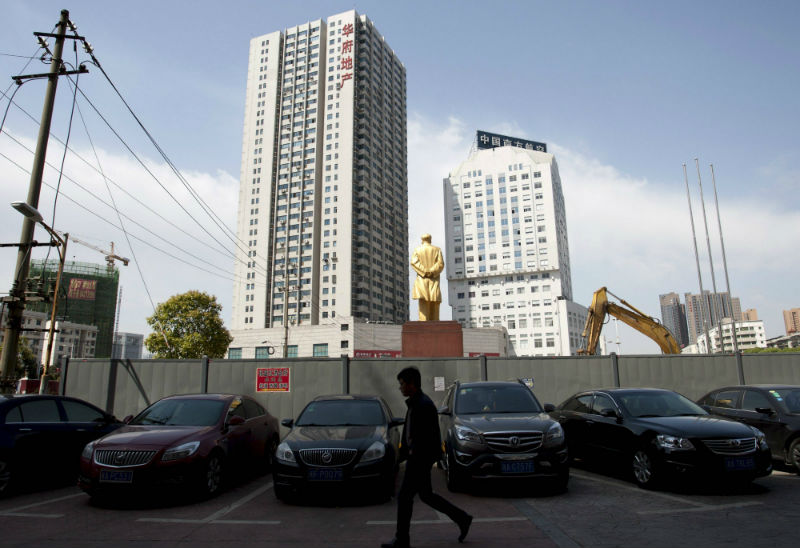 A man walks past a subway construction site, in Changsha, Hunan province, April 13, 2015. Since February last year, China has approved at least 1.8 trillion yuan in new infrastructure projects to counter a slowing economy. u00e2u20acu201d Reuters pic