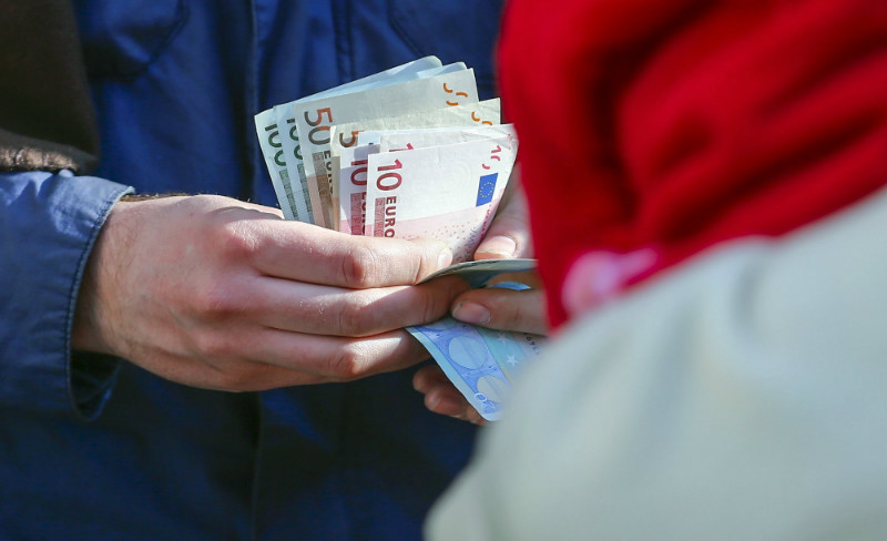 A customer counts his euro notes as he waits to buy the Apple Watch at a store in Berlin, Germany. The Apple Watch goes on sale around the world on April 24, 2015. u00e2u20acu201d Reuters pic
