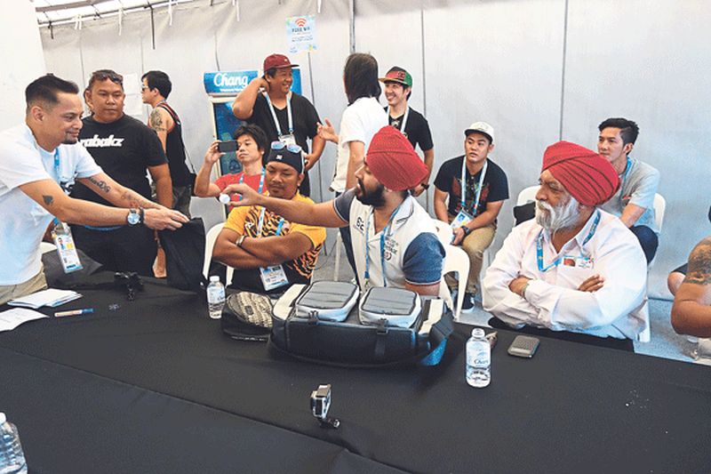 Darshan witnessing the drawing of teams for the Asian Beach Games 2014 Phuket. In the centre is Manjit Singh, secretary general of Asian Extreme Sports Federation. u00e2u20acu201d Malay Mail pic