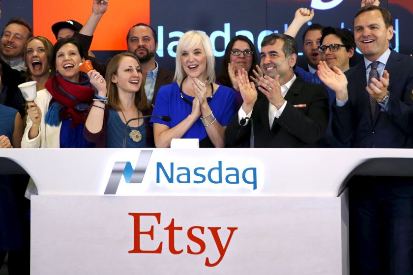 Etsy Inc's Chief Executive Officer Chad Dickerson (second right) and Chief Financial Officer Kristina Salen (centre) stand with Etsy employees and Nasdaq Executive Vice President Bruce Aust (right) as they celebrate Etsy's initial public offering (IPO) at
