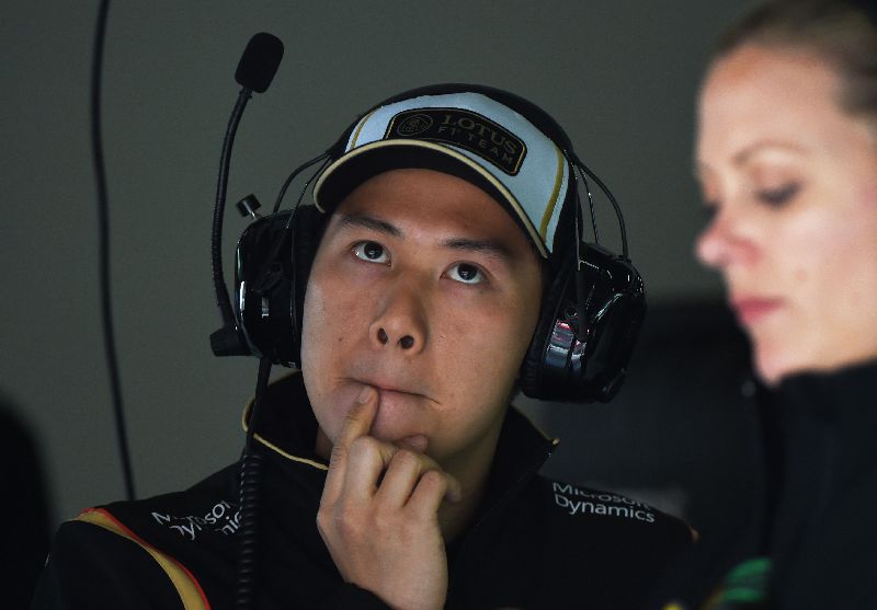 Lotus F1 team development driver Adderly Fong April 10, 2015, watching a monitor in the team garage during practice ahead of the Formula One Chinese Grand Prix in Shanghai. AFP PHOTO / Greg BAKER