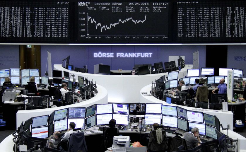 Traders are pictured at their desks in front of the DAX board at the Frankfurt stock exchange April 9, 2015. u00e2u20acu201d Reuters pic