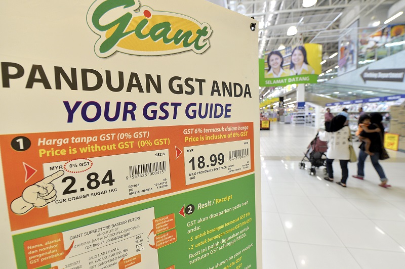 A signboard explaining how the GST works is seen at the Giant store in Kota Damansara, April 2, 2015. u00e2u20acu201d Bernama pic