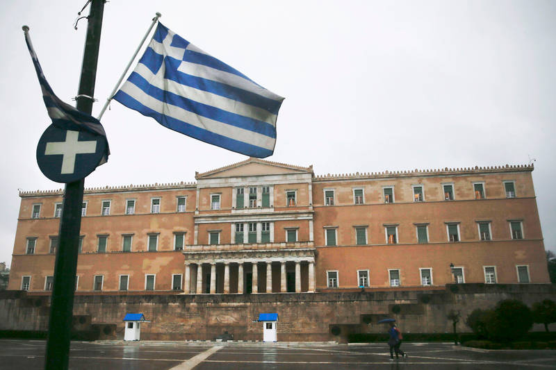 A Greek national flag flutters in front of the parliament building in Athens March 13, 2015. u00e2u20acu201d Reuters pic
