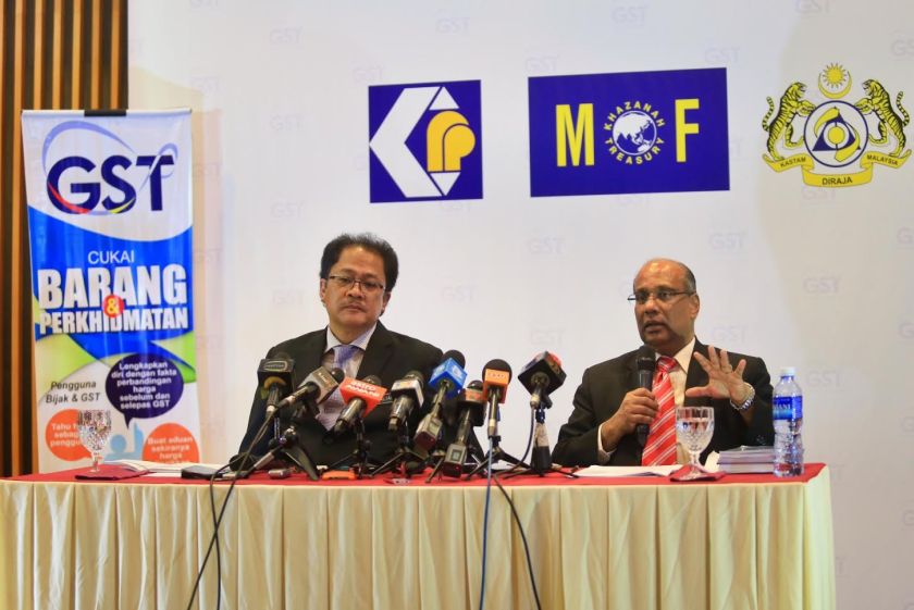 Domestic Trade, Cooperatives and Consumerism Ministry secretary-general Datuk Seri Alias Ahmad (left) and Customs Department GST division director Datuk T. Subromaniam speak at a press conference on the GST, April 9, 2015. u00e2u20acu201d Picture by Saw Siow Feng