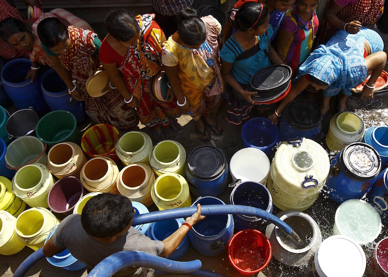 Residents get their containers filled with drinking water from a municipal water tanker at a slum in Kolkata March 22, 2015. u00e2u20acu201d Reuters pic