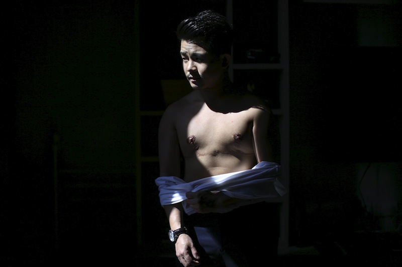 Joe Wong, 31, poses for photograph at his apartment in Bangkok April 3, 2015. u00e2u20acu201du00c2u00a0Reuters pic