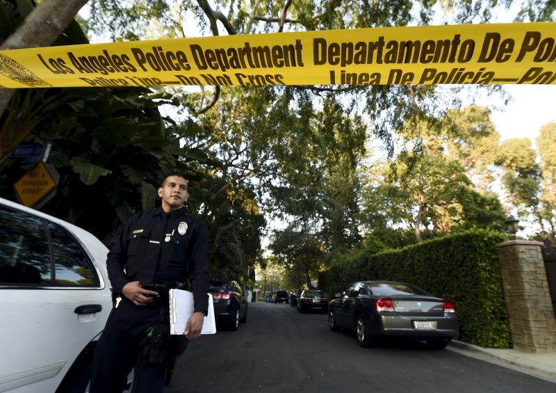 A Los Angeles Police Department officer stands behind yellow tape blocking off the street leading to the house of Andrew Getty in the Hollywood Hills section of Los Angeles, California March 31, 2015. u00e2u20acu2022 Reuters pic