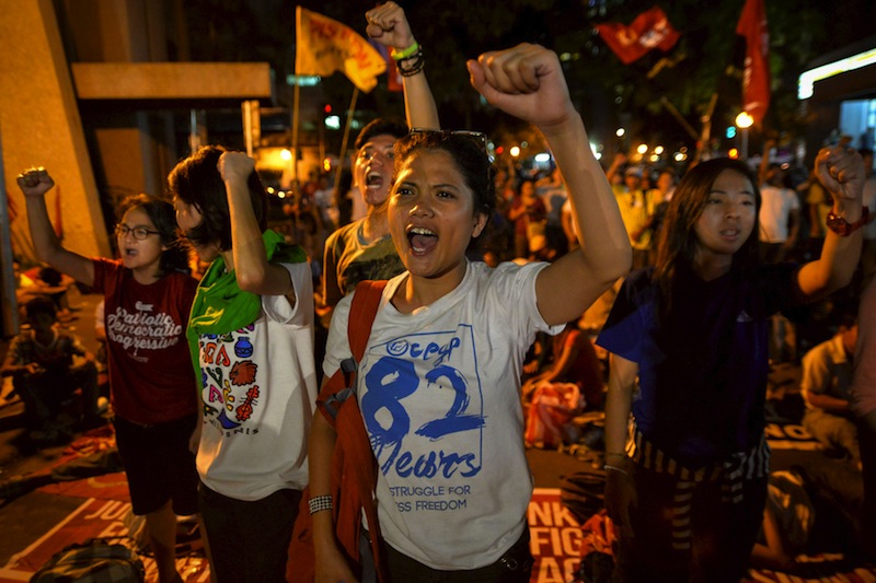 Activists clench their fists as they react after it was announced that the execution was delayed for death row prisoner Mary Jane Veloso, during a vigil outside Indonesian embassy in Makati, Philippines April 29, 2015. u00e2u20acu201d Reuters pic