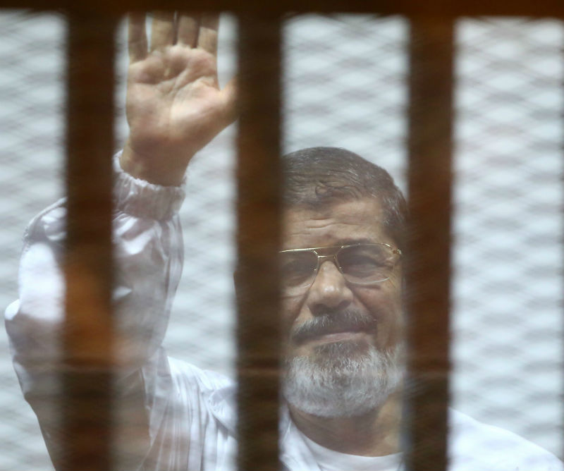 File picture shows Egyptu00e2u20acu2122s deposed Islamist president Mohamed Mursi waving inside the defendantu00e2u20acu2122s cage during a trial at the police academy in Cairo. u00e2u20acu201d AFP pic