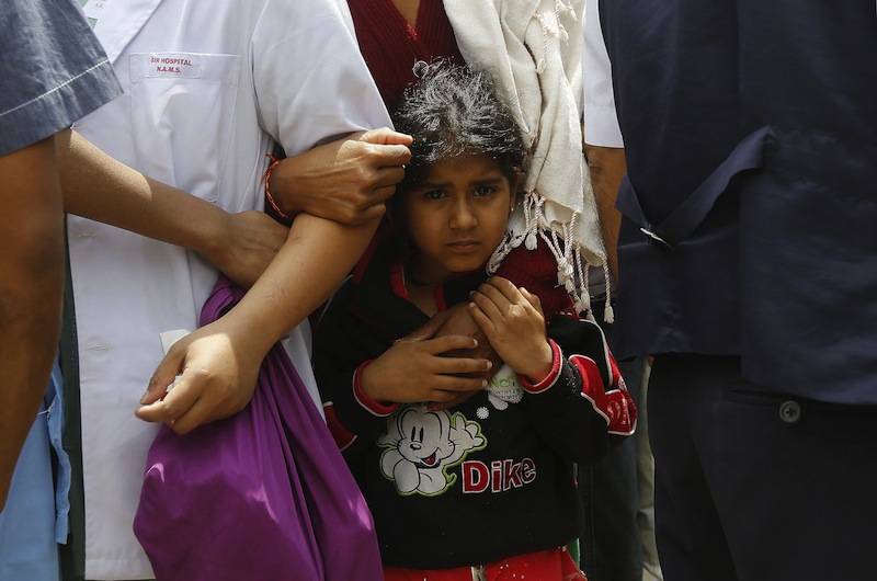 A girl holds her mother as they stand outside a hospital during a strong aftershock after an earthquake in Kathmandu, Nepal April 26, 2015, a day after the 7.9 magnitude earthquake killed more than 2,400 people and devastated Kathmandu valley.u00c2u00a0u00e2u20acu201d Reuter