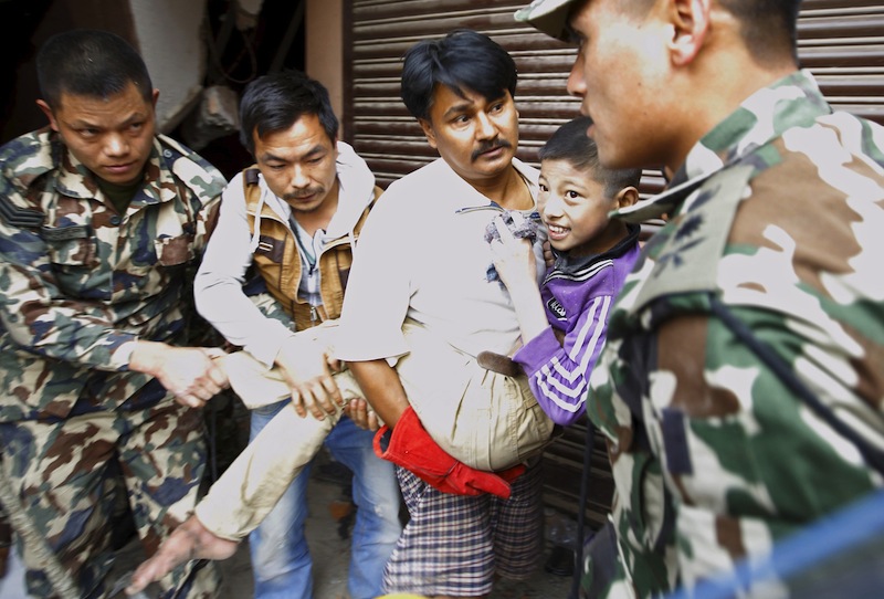 A boy smiles as he is rescued from a collapsed house after a 7.9 magnitude earthquake hit, in Kathmandu, Nepal April 25, 2015. u00e2u20acu201d Reuters pic