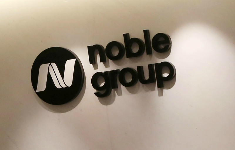 An employee is reflected on the wall as she walks past a signage of Noble Resources, a Noble Group subsidiary, at their premises in Singapore in this March 6, 2015 file photo. u00e2u20acu201d Reuters pic