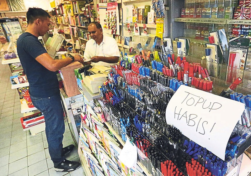 Many shops in Taman Canning, Ipoh have run out of prepaid reload coupons. The uncertainty over the price of the coupons has not only affected users but also sellers. u00e2u20acu201d Picture by Farhan Najib