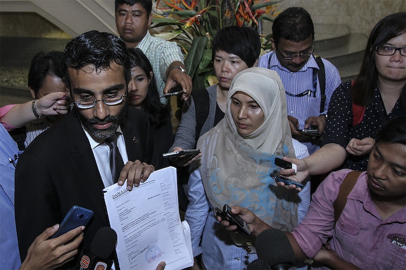 Datuk Seri Anwar Ibrahim's lawyer N. Surendran and daughter Nurul Izzah Anwar speaks to the media after the Opposition Leader applied for a review of his sodomy conviction at the Federal Court in Putrajaya, April 30, 2015. u00e2u20acu201d Picture by Yusof Mat Isa 