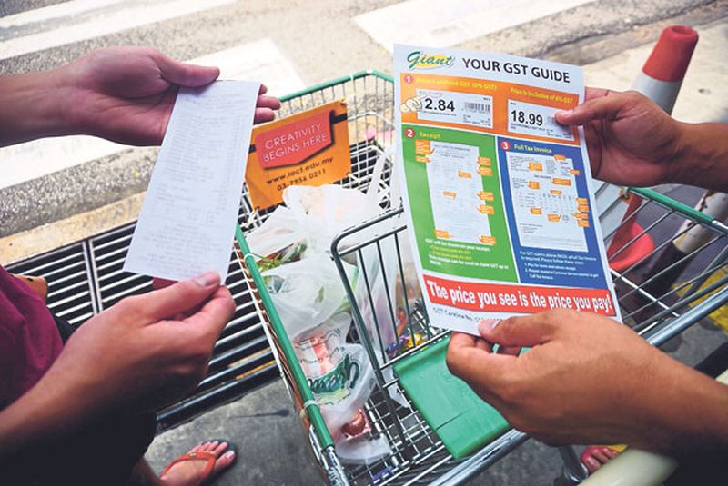 Shoppers check if they are being charged GST correctly. Consumer groups and activists say the big number of complaints following the implementation of the tax shows consumerism is alive and well. u00e2u20acu2022 Malay Mail pic