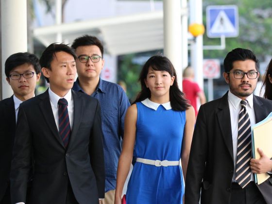 The duo behind The Real Singapore, Ai Takagi (second right) and Yang Kaiheng (third right), arriving at court on April 14, 2015. u00e2u20acu201d TODAY pic 