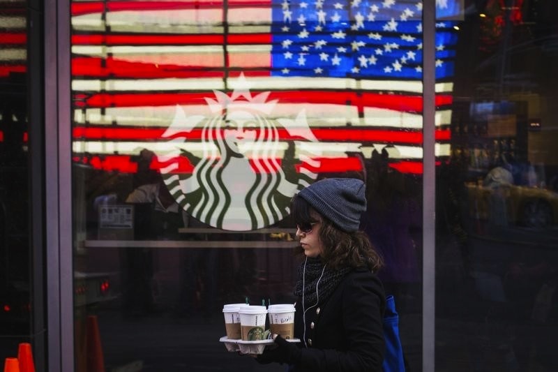 A woman carries coffee out of a Starbucks store in the Manhattan borough of New York January 24, 2014. u00e2u20acu201d Reuters pic