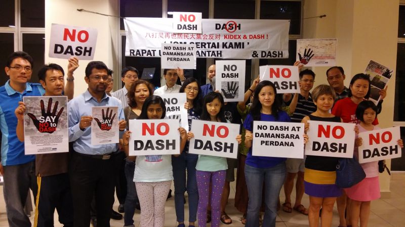 Damansara Perdana residents and Say No to Dash (SNTD) representatives holding up banners and placards opposing the Damansara-Shah Alam Highway (Dash) after the press conference. u00e2u20acu2022 Picture by Yiswaree Palansamy 