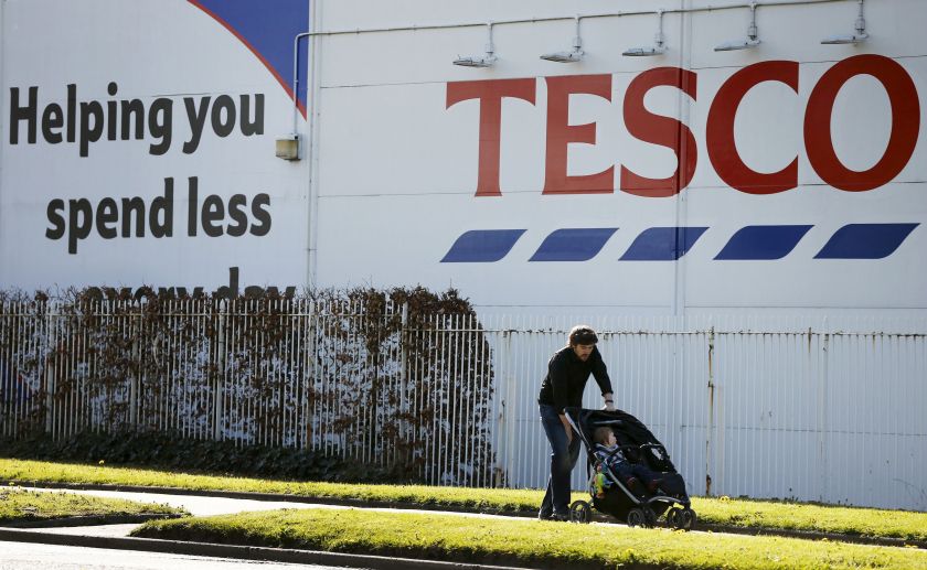 A man pushes a pram past a Tesco supermarket near Altrincham, northern England, April 22, 2015. u00e2u20acu201d Reuters pic