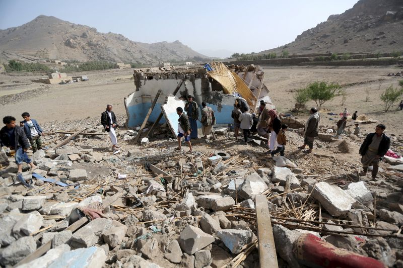 People gather on the wreckage of a house destroyed by an air strike in the Bait Rejal village west of Yemen's capital Sanaa April 7, 2015. u00e2u20acu2022 Reuters pic