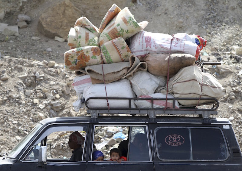 A family flees with their belongings, fearing renewed air strikes in Sanaa April 2, 2015. u00e2u20acu201d Reuters picn