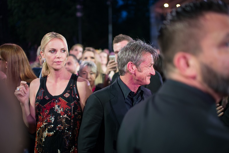 Charlize Theron (left) and Sean Penn (centre) arrive at the opening ceremony of the 23rd Life Ball in Vienna on May 16, 2015. — AFP pic