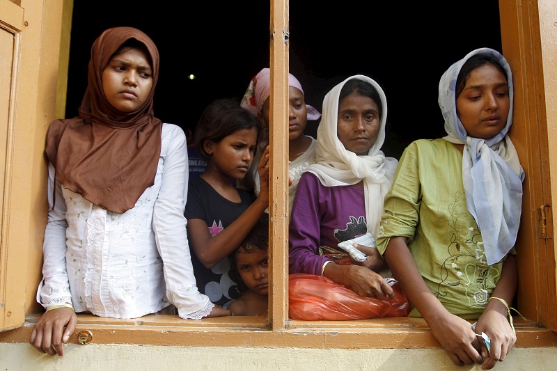 Migrants, believed to be Rohingya, look out the window of a shelter they are staying at since being rescued along with hundreds of others on Sunday from boats in Lhoksukon, Indonesiau00e2u20acu02dcs Aceh Province May 12, 2015. u00e2u20acu201d Reuters pic