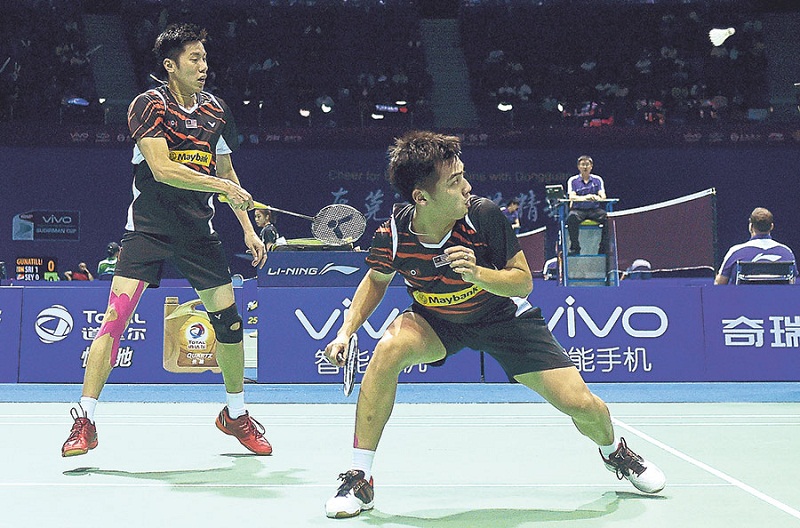 Goh V Shem (left) and Tan Wee Kiong failed to repeat their group stage heroics against Lee and Yoo. u00e2u20acu201d Picture by AFP