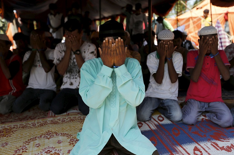 Rohingya migrants, who recently arrived in Indonesia by boat, attend a mass prayer inside a temporary compound for refugees in Aceh Timur regency, Indonesiau00e2u20acu02dcs Aceh Province May 21, 2015.u00e2u20acu201d Reuters pic