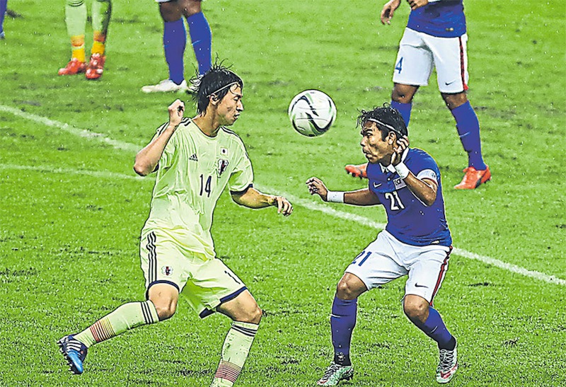 Nazirul (right) played a captainu00e2u20acu2122s role holding the defence against Japan in the Under-23 qualifiers in March. u00e2u20acu201d Picture by Kamarul Akhir