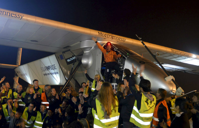 Swiss pilot Bertrand Piccard (top) waves to staff from the cockpit of Solar Impulse 2 plane as he celebrates after the plane landed at Nanjing Lukou International Airport, China, April 22, 2015. u00e2u20acu201d Reuters pic