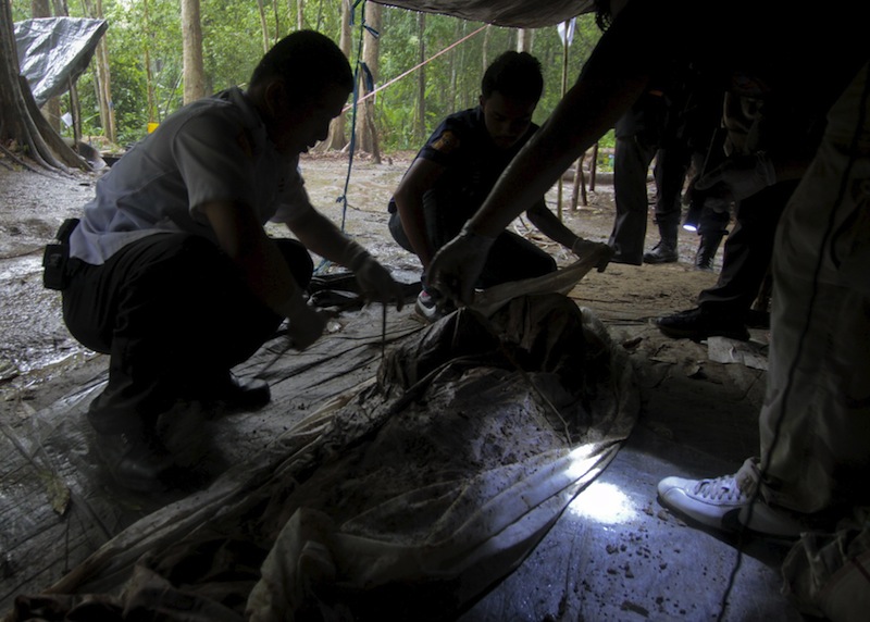 Human remains are retrieved from a mass grave at a rubber plantation near a mountain in Thailand's southern Songkhla province May 7, 2015.u00c2u00a0u00e2u20acu201d Reuters pic