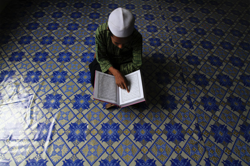 A Rohingya boy, Rofi Nasir Ahmed, 10, recites the Quran before performing Zuhur prayers at the Madrasah Muiin Al-Islam in Meru Klang, May 28, 2015. u00e2u20acu201d Picture by Yusof Mat Isa 