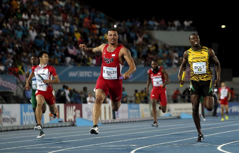 Ryan Bailey of the US (C) crosses the finish line ahead of Jamaicau00e2u20acu2122s Usain Bolt (R) as the US win the 4x100 metres, IAAF World Relays Championships in Nassau, Bahamas, May 2, 2015. Japanu00e2u20acu2122s Kotaro Taniguchi is at left. REUTERS/Mike Segar