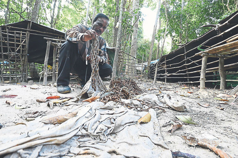 The writer with the chain that could have been used to shackle victims of people smugglers.