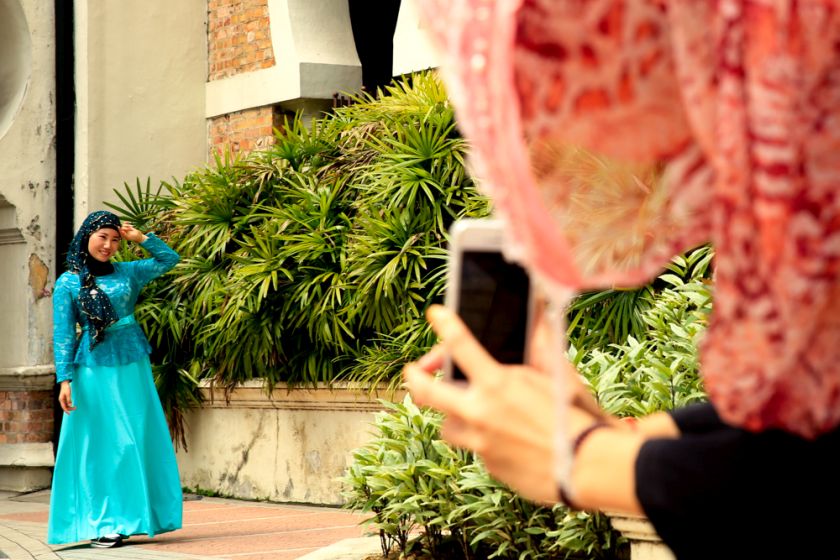 A China Muslim tourist poses for pictures at Dataran Merdeka, Kuala Lumpur, May 13, 2015. u00e2u20acu2022 Picture by Saw Siow Feng