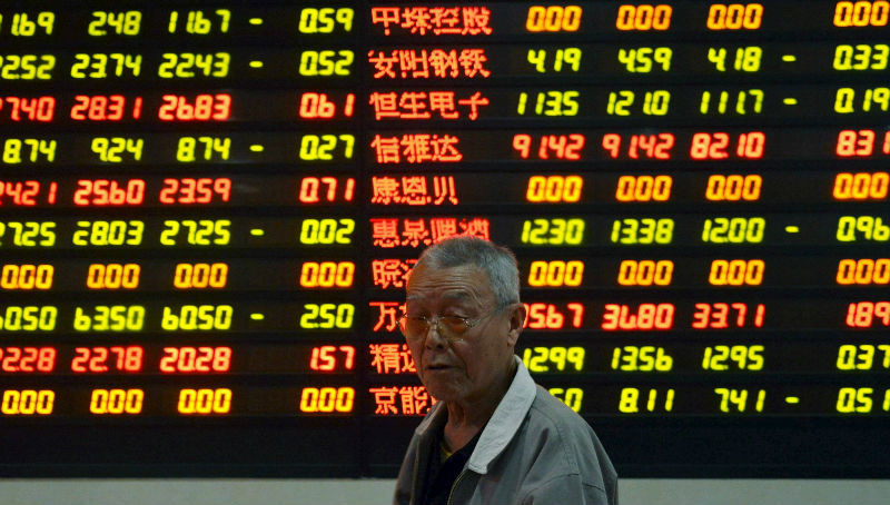 nAn investor stands in front of a screen showing stock information in Hangzhou, Zhejiang province, China, May 6, 2015. China stocks surrendered early gains and ended lower. u00e2u20acu201d Reuters picn