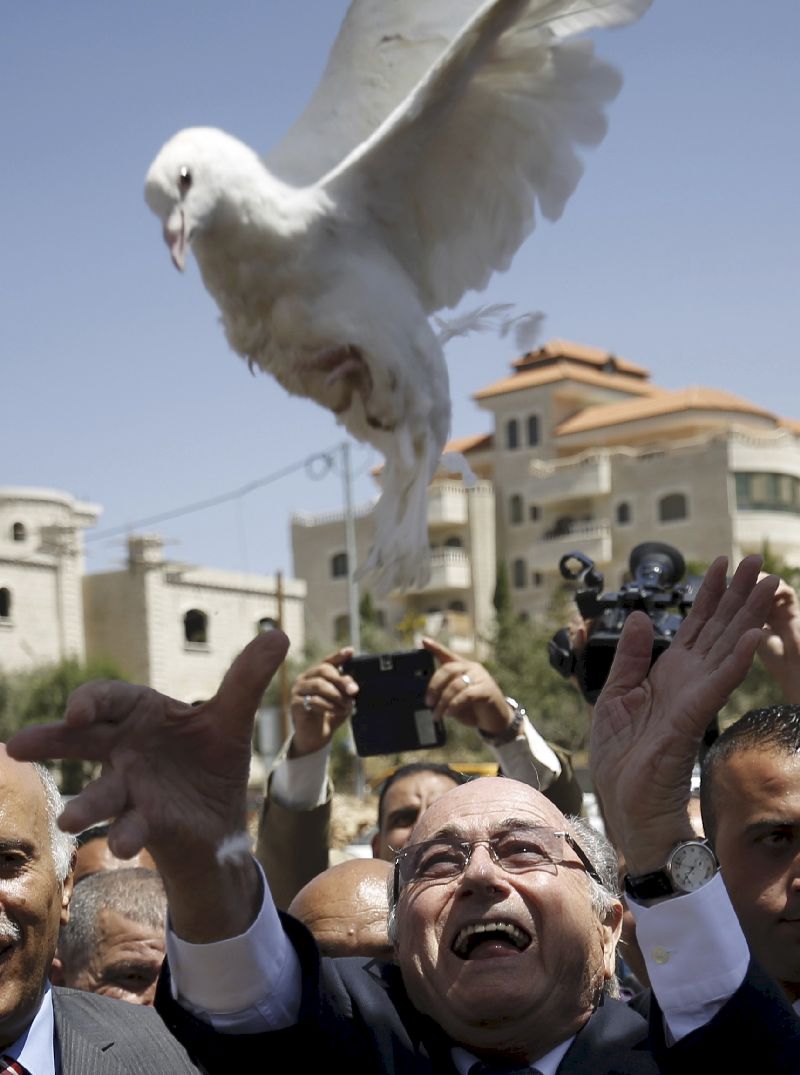 Sepp Blatter releases a dove during a visit to Dura al-Qar’ village in the West Bank city of Ramallah, May 20, 2015. 