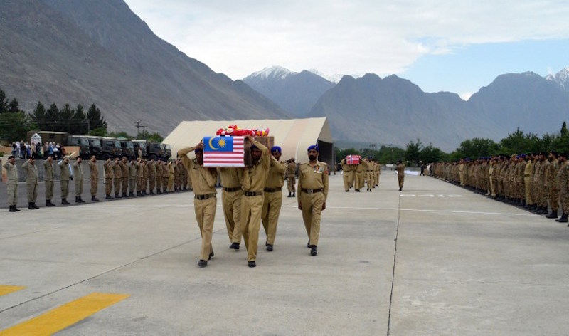 Pakistani soldiers carry the coffins of the wife of the Malaysian ambassador Datin Habibah Mahmud and the Norwegian ambassador Leif H Larsen during a ceremony in Gilgit May 9, 2015. u00e2u20acu201d AFP pic