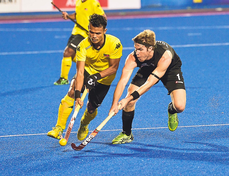Noor Nabil (left) is challenged by New Zealandu00e2u20acu2122s Goughlan James in Malaysiau00e2u20acu2122s 4-2 defeat at the Azlan Shah Cup match in Ipoh in April. The new office bearers have to clear the debts and revive the ailing national team. u00e2u20acu201d File picture 