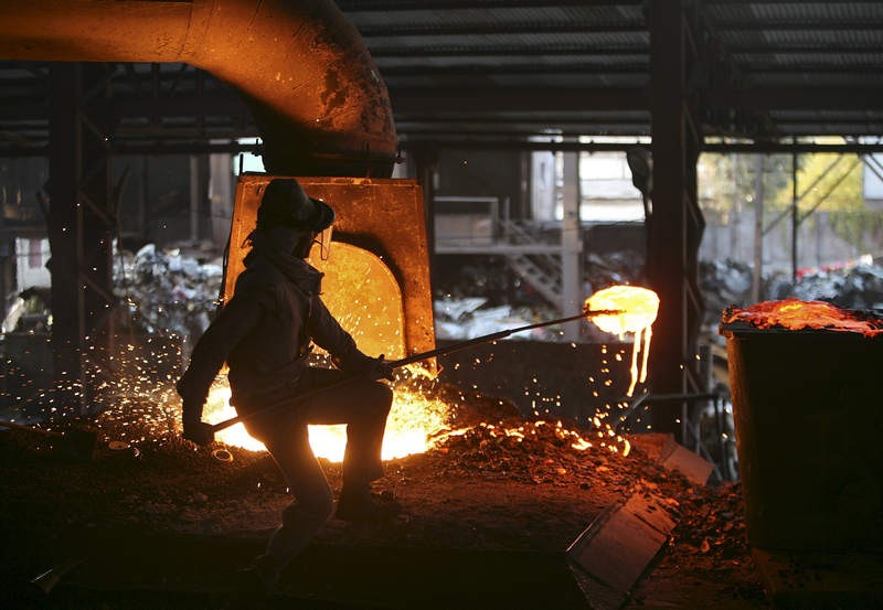 A labourer works inside a steel factory on the outskirts of Jammu, January 2, 2014 u00e2u20acu201d AFP pic