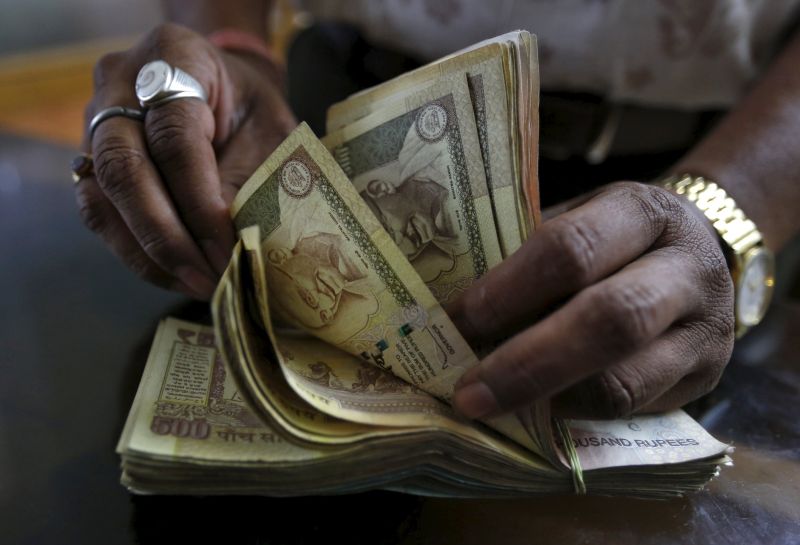 A money lender counts Indian rupee currency notes at his shop in Ahmedabad, India, May 9, 2015. u00e2u20acu2022 Reuters pic