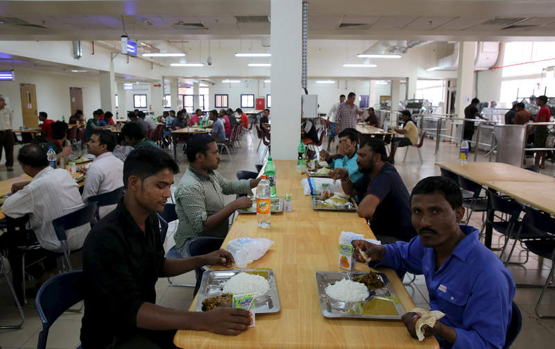 Labourers eat at a foreign workers dormitory site in the Sanaya Industrial Area in Doha, May 3, 2015. u00e2u20acu201d Reuters pic