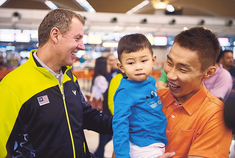 Frost looks on as Lee carries his son, Kingston, before departing for Dongguan on Wednesday. u00e2u20acu201d Picture by Bernama